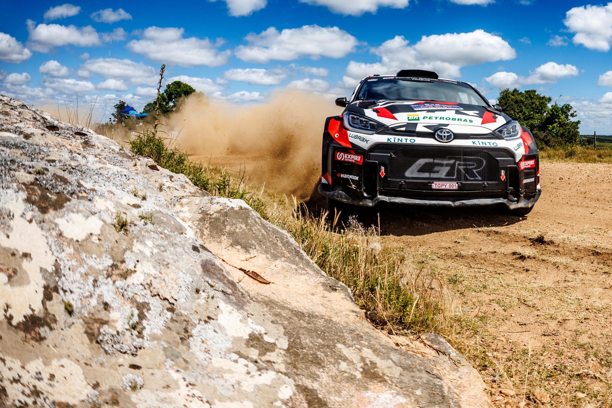 Vehículo de rally compitiendo levantando arena